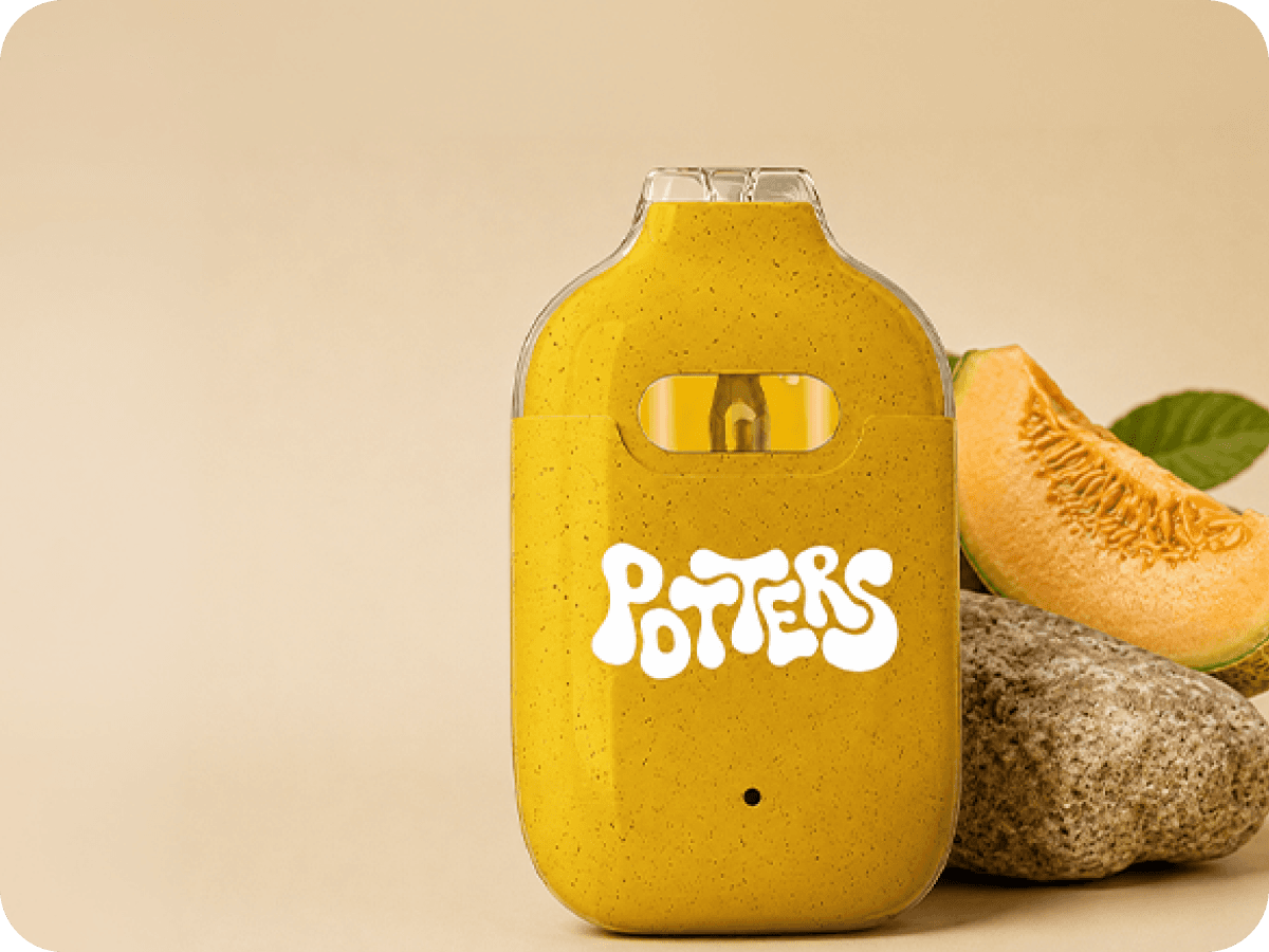 Potter's yellow live resin vape beside cantaloupe and a stone.